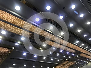 A Golden shaded white color painted gypsum ceiling emulsion painted and decorated with many down lights for an garments store