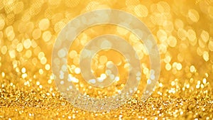 Golden shiny background for Christmas greetings. Banner with defocused lights, bright yellow bokeh. Shimmer of gold