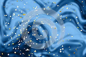 Golden shiny confetti on neon holographic background toning in classic blue color, creative design of 2020. Sparkles shap