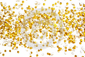 Golden shiny confetti on a white background.