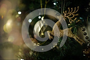 Golden and shiny deer decoration on a christmas tree.