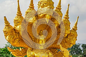Golden shiny statue of Buddha and dragons in the temple in Phuket. Thailand