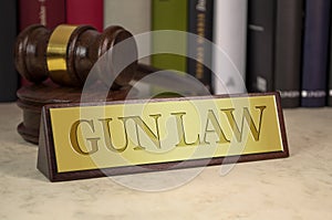 Golden sign with gavel and gun law