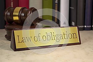 Golden sign with gavel with law of obligation