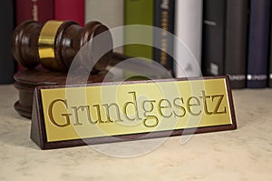 Golden sign with law books, gavel and the german word for constitution - grundgesetz