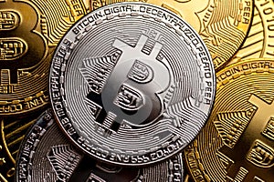 Golden and silver bitcoin coins, close-up.