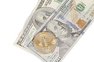 Golden and silver bitcoin coins and one hundred dollar banknote