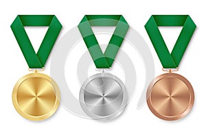 Golden silver and bronze award sport medal with green ribbons