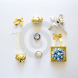 Golden and silver Christmas gift boxes and decorations on white background. Flat lay. Top view