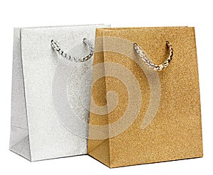 Golden and silver gift bags on white