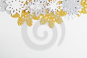 Golden, silver and white paper snowflakes on white background. New year, christmas concept