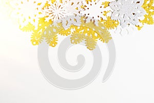 Golden, silver and white paper snowflakes on white background. New year, christmas concept