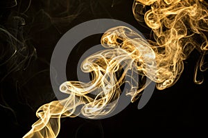 Smoke gold on a black background photo