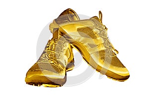 Golden sneakers white background isolated closeup, gold metal sport shoes, luxury running gumshoes, yellow metallic fitness boots