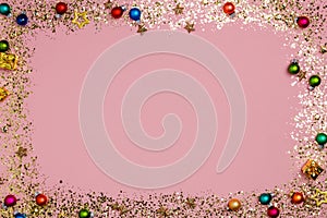 Golden sparkle glittering Christmas frame, pink background, top view