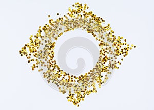 Golden sparkle glittering round frame in the form of a rhombus on white  background with copy space.  Holidays and glamour concept