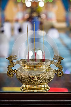 Golden spiritual vase with smoking aromatic candles