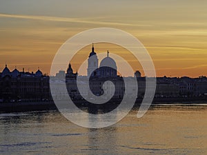 Golden spring sunset in city. Saint Petersburg cityscape over Neva River in Russia. City skyline colorful photo with historical