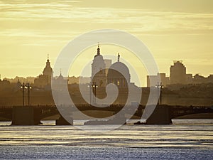 Golden spring sunset over the bridge. Saint Petersburg cityscape over Neva River in Russia. City skyline colorful photo with