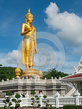 Golden standing Buddha in Hat Yai, Thailand photo