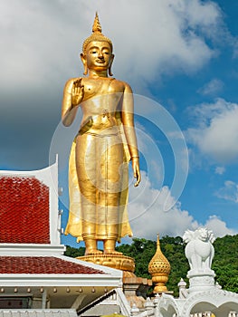 Golden standing Buddha in Hat Yai, Thailand photo