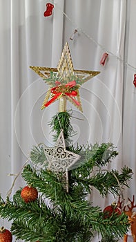 Golden star decoration, decorative traditional shiny design for top of Xmas pine tree in winter season