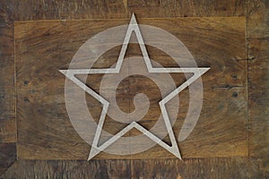 golden star isolated on wooden background