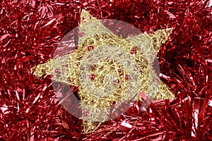 Golden star over a red garland. Christmas decoration