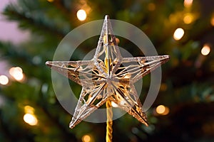 Golden Star Tree Topper Shines Bright on Christmas Tree at Night