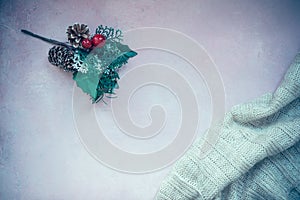 Golden stars, gift box, christmas tree branch and decorations on light pink textured background.