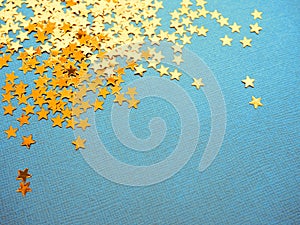 Golden stars glitter on blue background