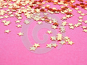 Golden stars glitter on pink background