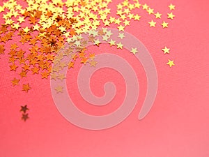 Golden stars glitter on pink background