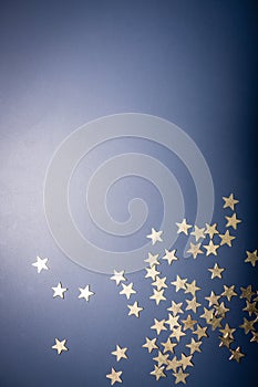 Golden stars isolated omn blue background with copy space.