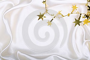 Golden stars and spangles on white silk