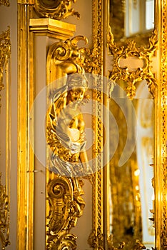 Golden statue in ballroom of roccoco palace Catherine Palace,  located in the town of Tsarskoye Selo or Pushkin St. Petersburg