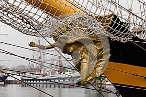 Golden statue on the bow of a ship