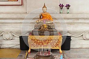 A golden statue of Buddha was installed under the hall of the main building of Wihan Phra Mongkhon Bophit in Ayutthaya (Thailand)
