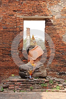 A golden statue of Buddha was put on a beheaded statue in the main building of Wat Phra Si Sanphet in Ayutthaya (Thailand)