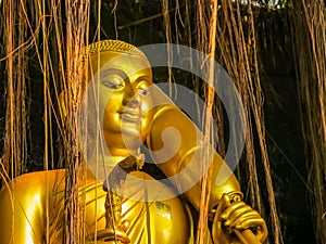 Golden Statue in bushes near Wat Saket Temple or Golden mount