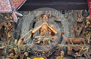 Golden Statue of Guanyin and Sudhana acompanied by their masters from the Jade Buddha Temple interior in Shanghai