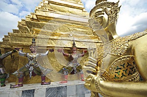 Golden statue of Kinnorn, Giants and Golden Chedi at Wat Phra Kaew in Bangkok, Thailand