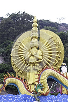 Golden statue with many hands and several heads at Khao Takiab Temple, Hua Hin