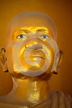 Golden Statue of a monk symbolic image head and face closeup Thailand