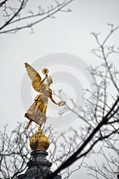 Golden statue of muse on top of Academy of Arts in Dresden