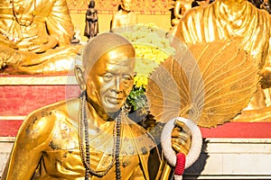 Golden statue of old buddhist monk in Chiang Mai