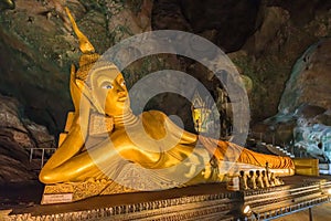 Golden statue of Reclining Buddha in Monkey Cave