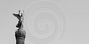 The Golden Statue of Victoria On Top of The Victory Column in Berlin, Germany Against A Blue Sky With Copy Space