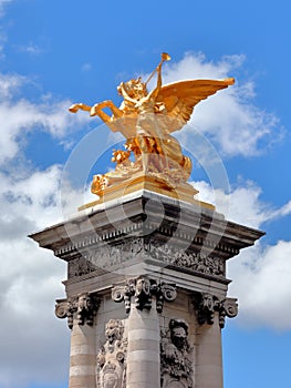 Golden statues on the Alexander III bridge in Paris