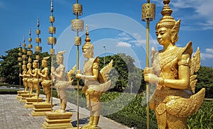 Golden statues in front of entrance of Bokor National Park Kampot province Cambodia